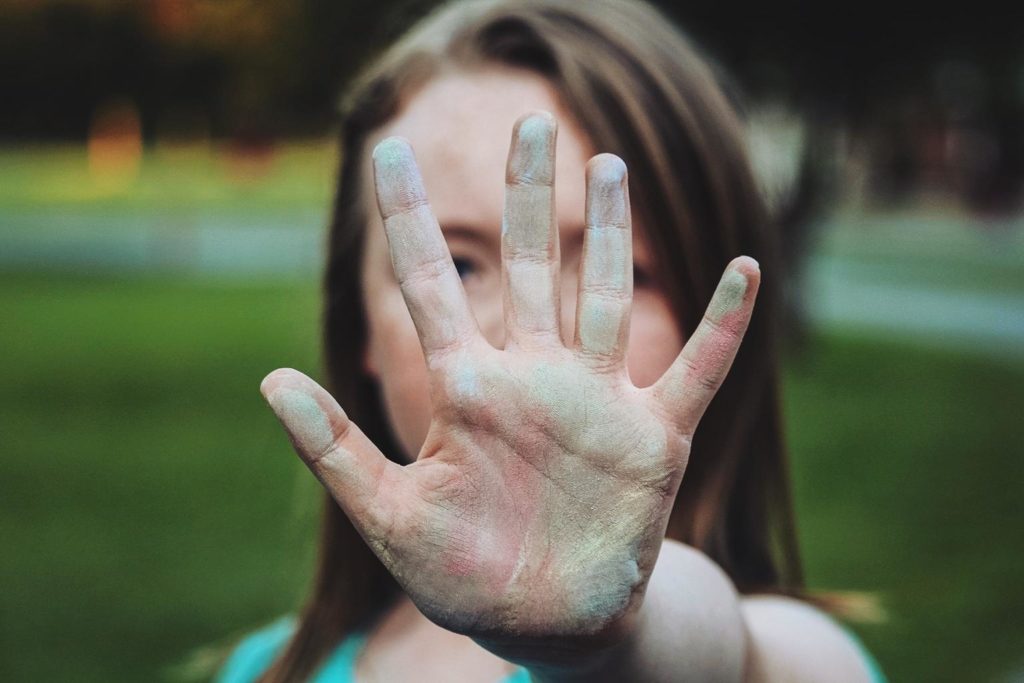 girl holding hand up to stop